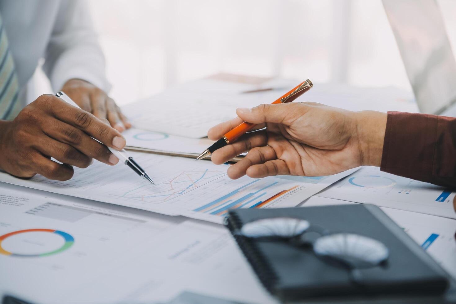 Business team collaboration discussing working analyzing with financial data and marketing growth report graph in team, presentation and brainstorming to strategy planning making profit of company. photo