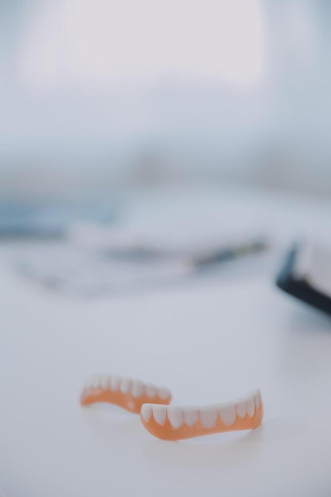 Denture and dental tools,dental mirror on white background photo