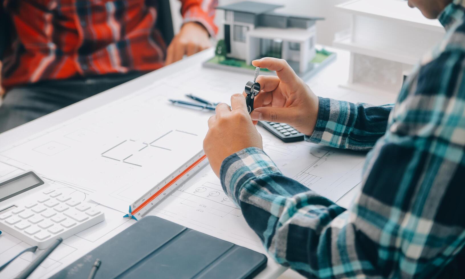 engineer people meeting working and pointing at a drawings in office for discussing. Engineering tools and construction concept. photo