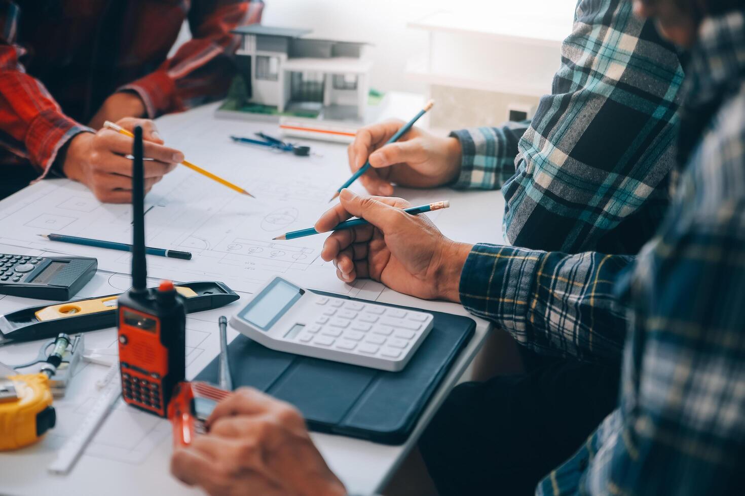 engineer people meeting working and pointing at a drawings in office for discussing. Engineering tools and construction concept. photo