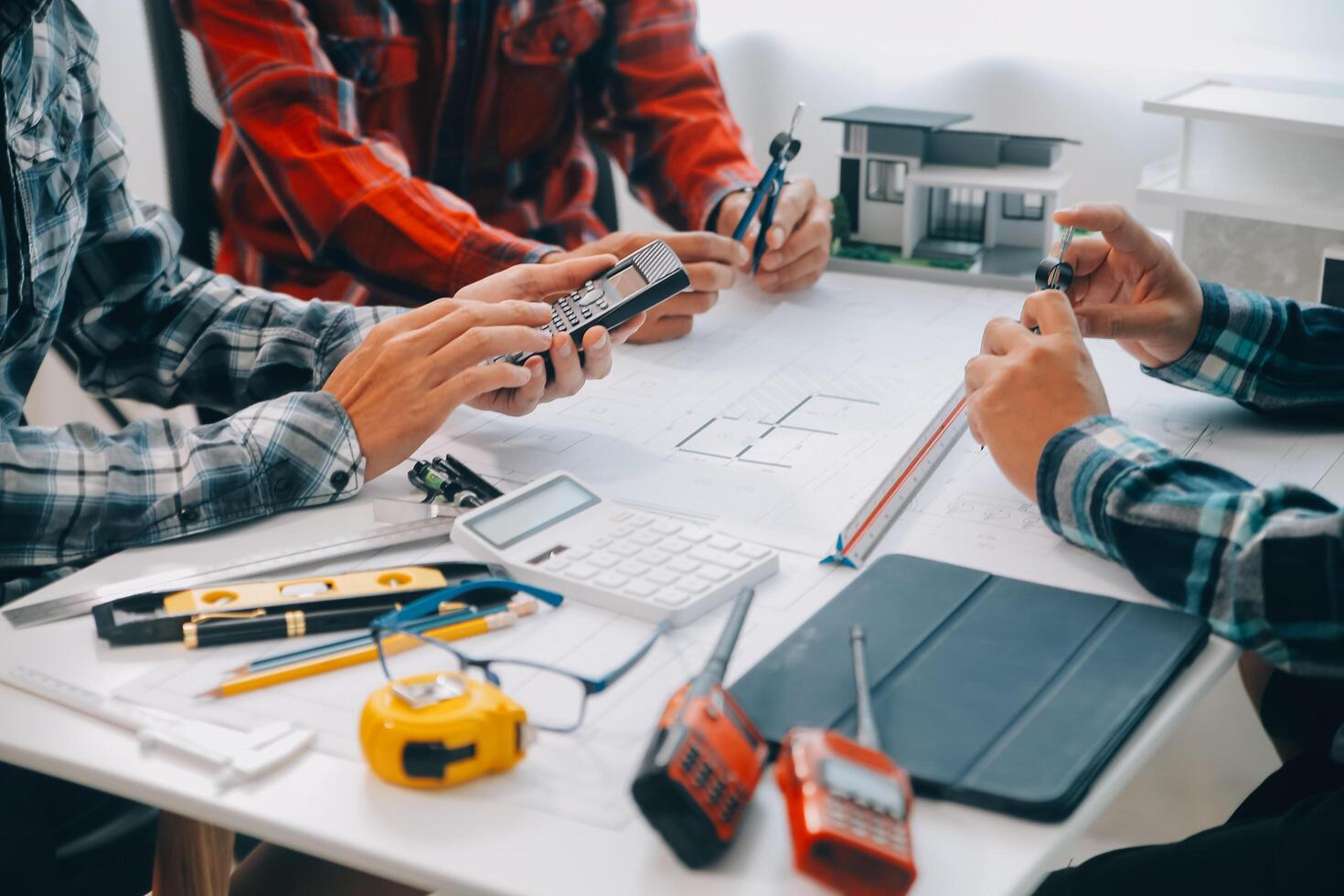 engineer people meeting working and pointing at a drawings in office for discussing. Engineering tools and construction concept. photo