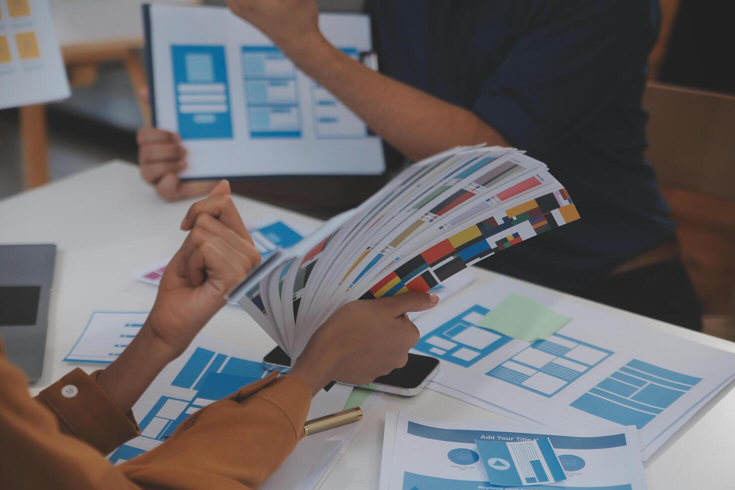 Close up ux developer and ui designer use augmented reality brainstorming about mobile app interface wireframe design on desk at modern office.Creative digital development agency photo