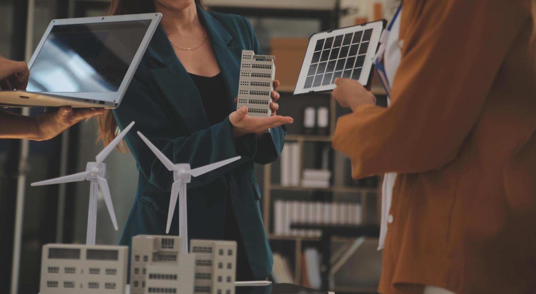 Electrical engineer with businessman discussing new project installation solar cell panel on the roof of building. Alternative energy concept. photo