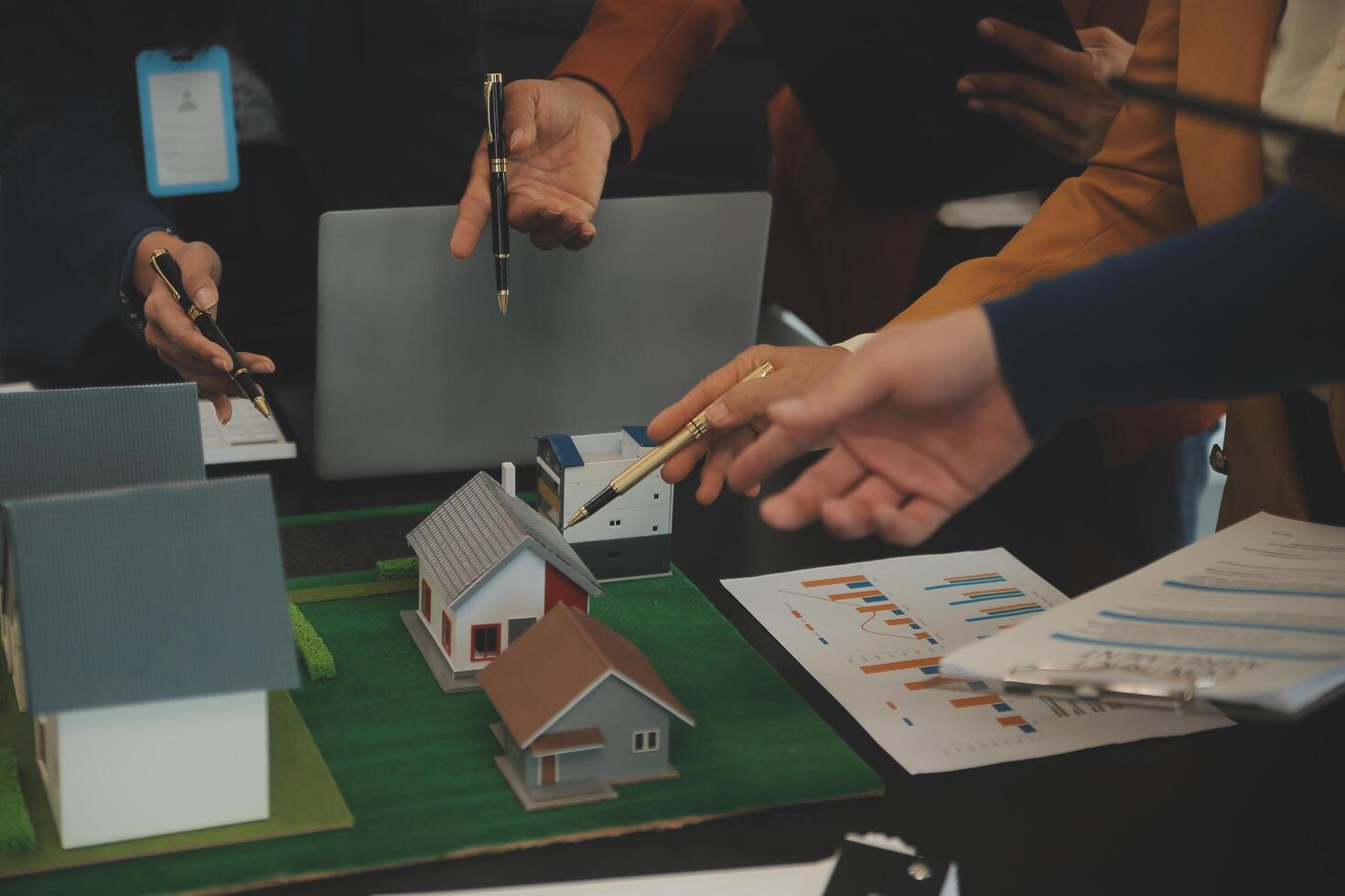 Team of architectures and businessmen discussing and brainstorming on floor plan modification for real estate investment and housing development project photo