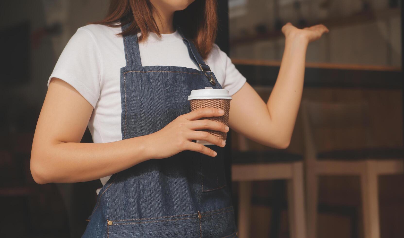 Startup successful small business owner sme beauty girl stand with tablet smartphone in coffee shop restaurant. Portrait of asian tan woman barista cafe owner. SME entrepreneur seller business concept photo