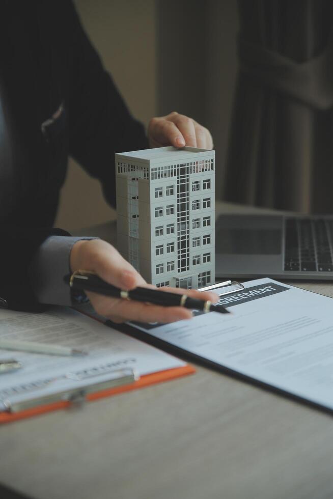 Real estate agent and customer signing contract to buy house, insurance or loan real estate.rent a house,get insurance or loan real estate or property. photo