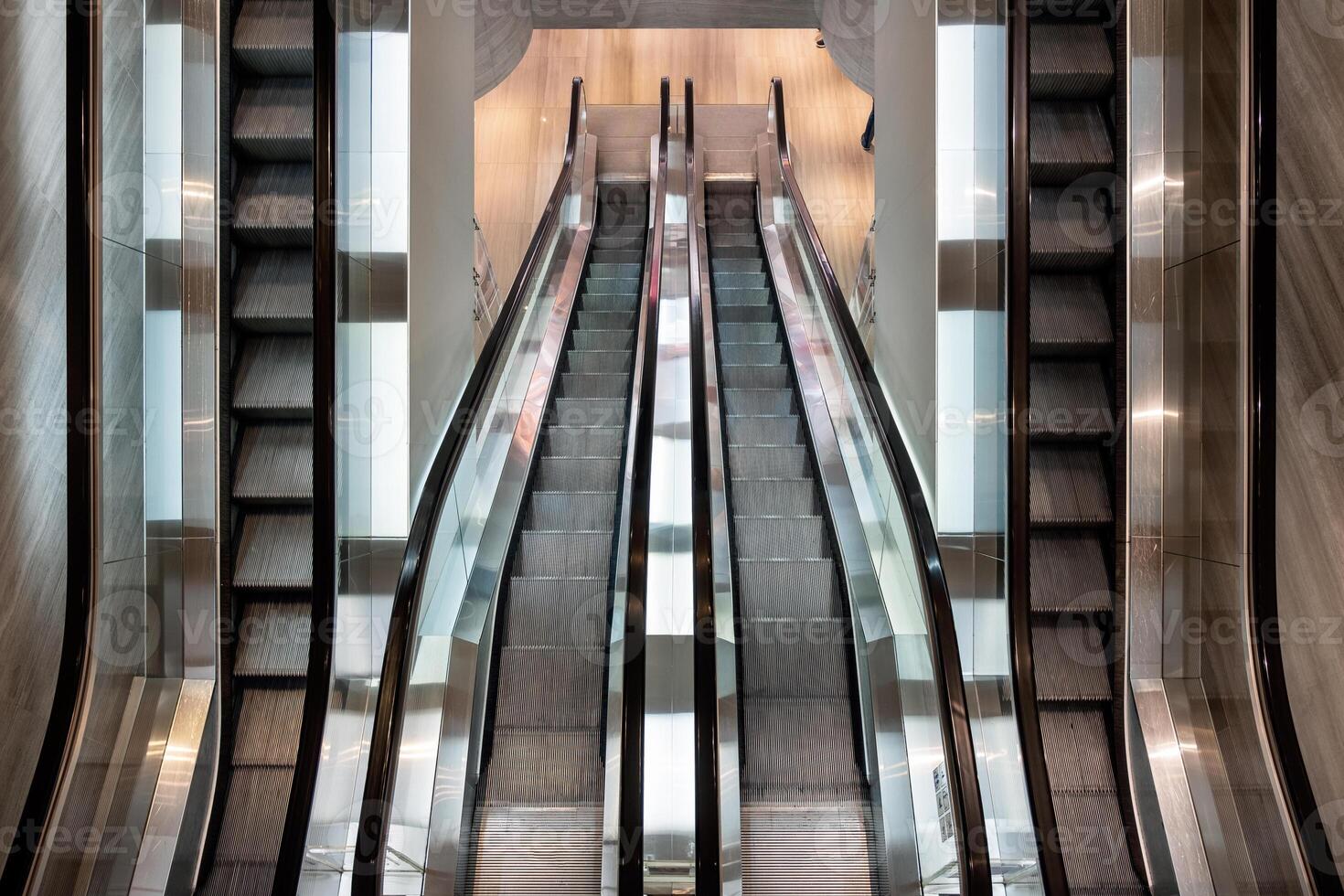 Modern escalator parallel moving in department store photo