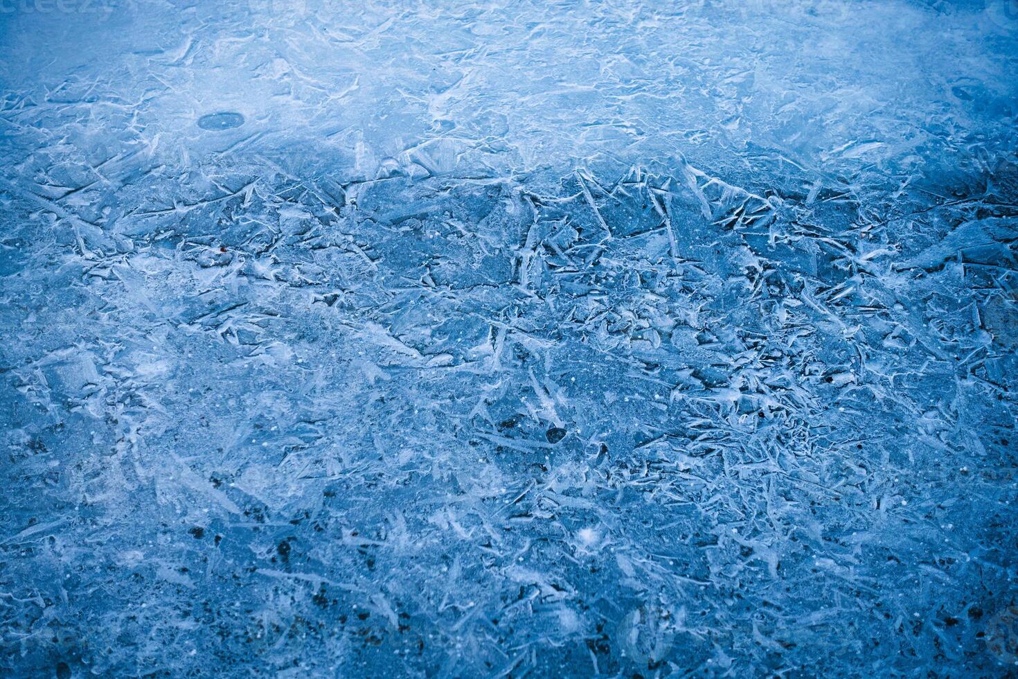 Natural cracked frozen lake textured pattern photo