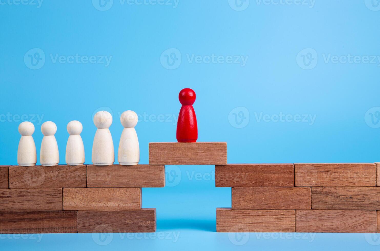 Wooden people figures on top of wooden blocks. Career growth, development and leadership photo