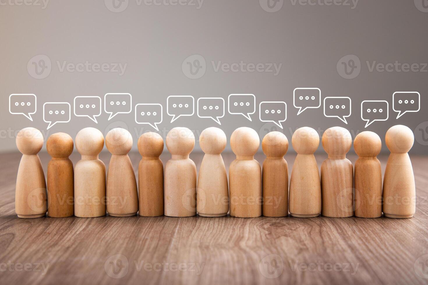 Wooden figurine with speech bubble. Mingle, discussion, chatting concept photo