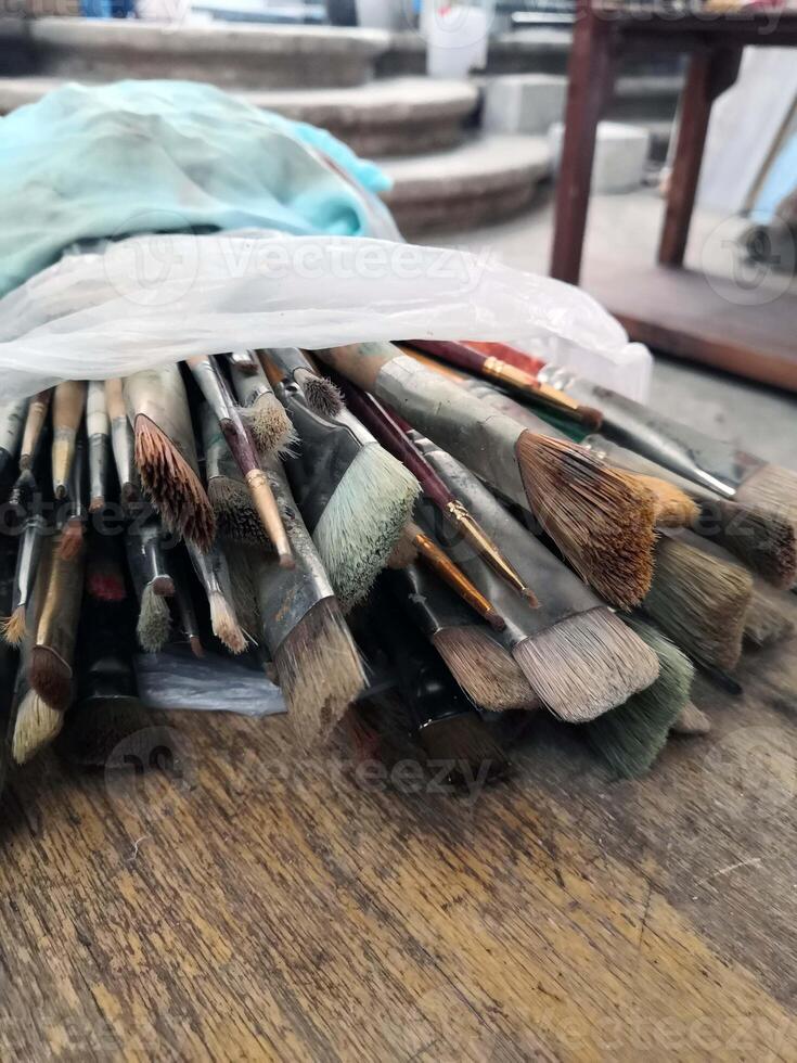 Various Brushes Arranged on Wooden Table photo