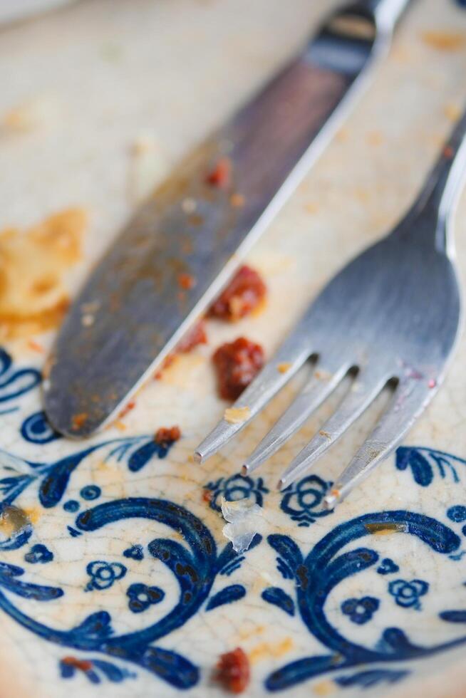 An empty dirty plate with a fork. photo