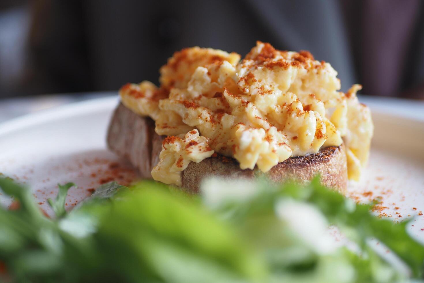 morning breakfast with Scrambled eggs on a bread on white plate photo