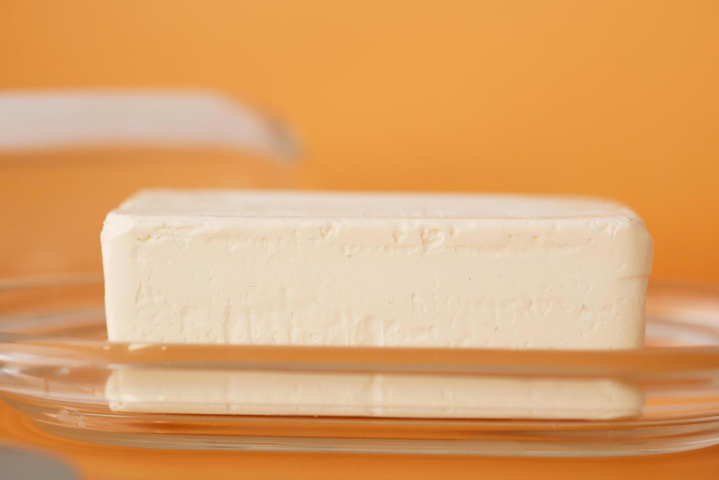 slice of a butter on a paper on table photo