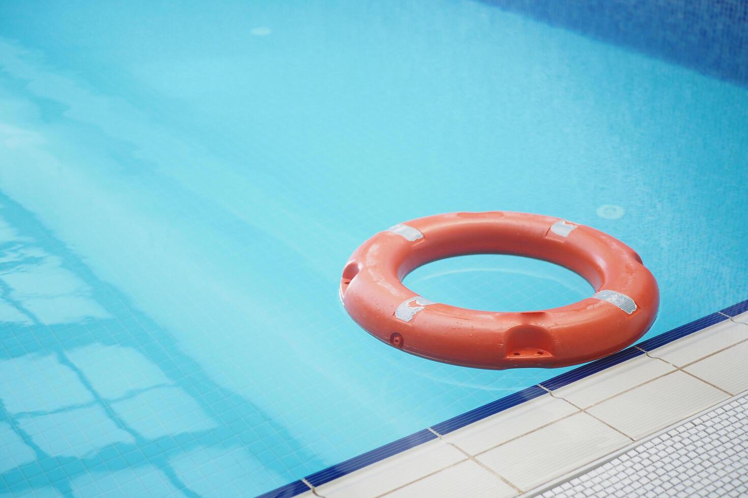 Red life buoy in swimming pool.. Help and support concept. photo