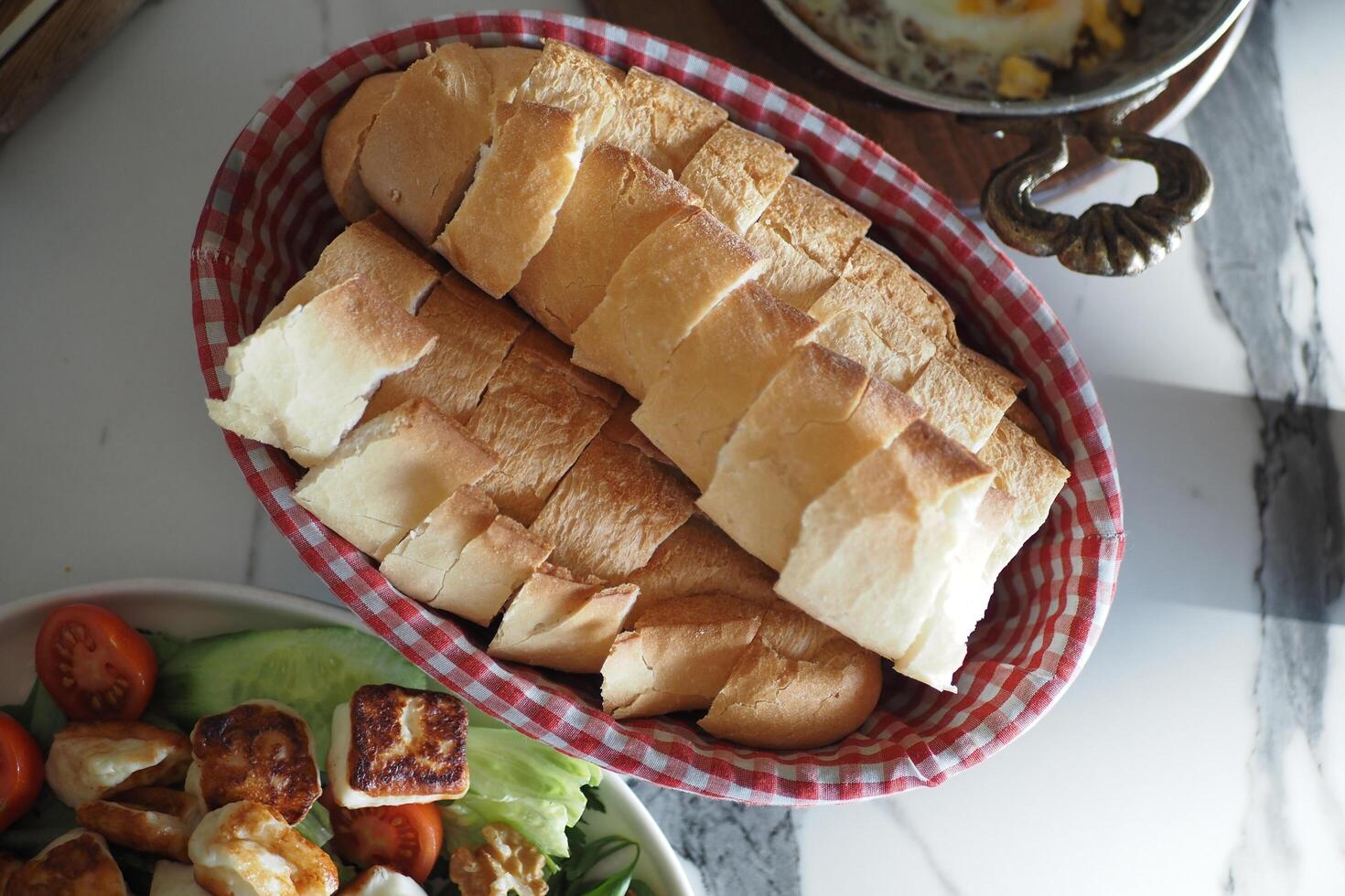 top view of bread rolls rest in a bowl on the table photo