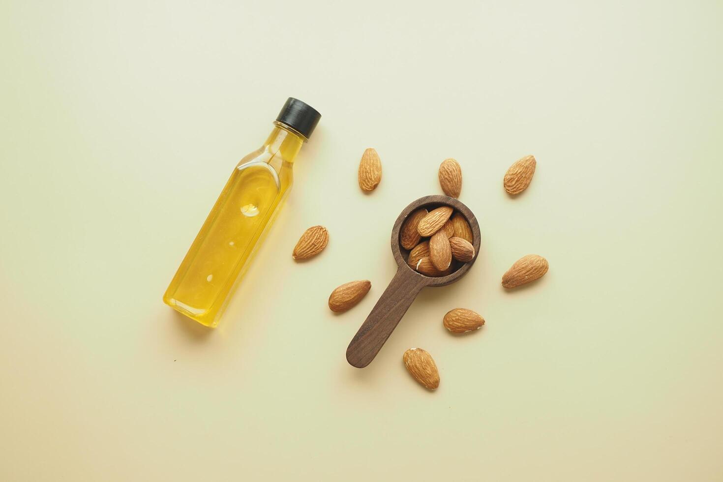 almond oils and fresh nuts on table photo