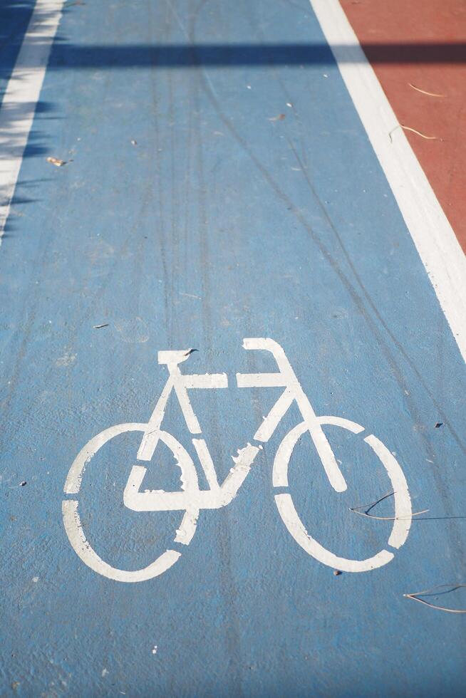 Bicycle symbol on the blue road surface photo