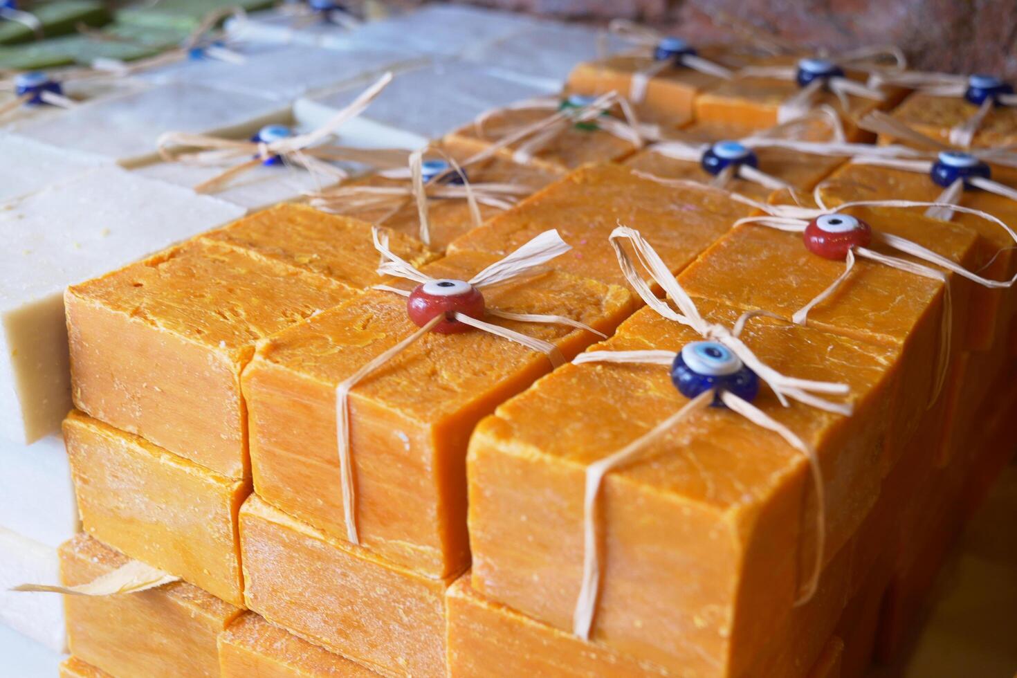 Stack of soap topped with evil eye beads, photo