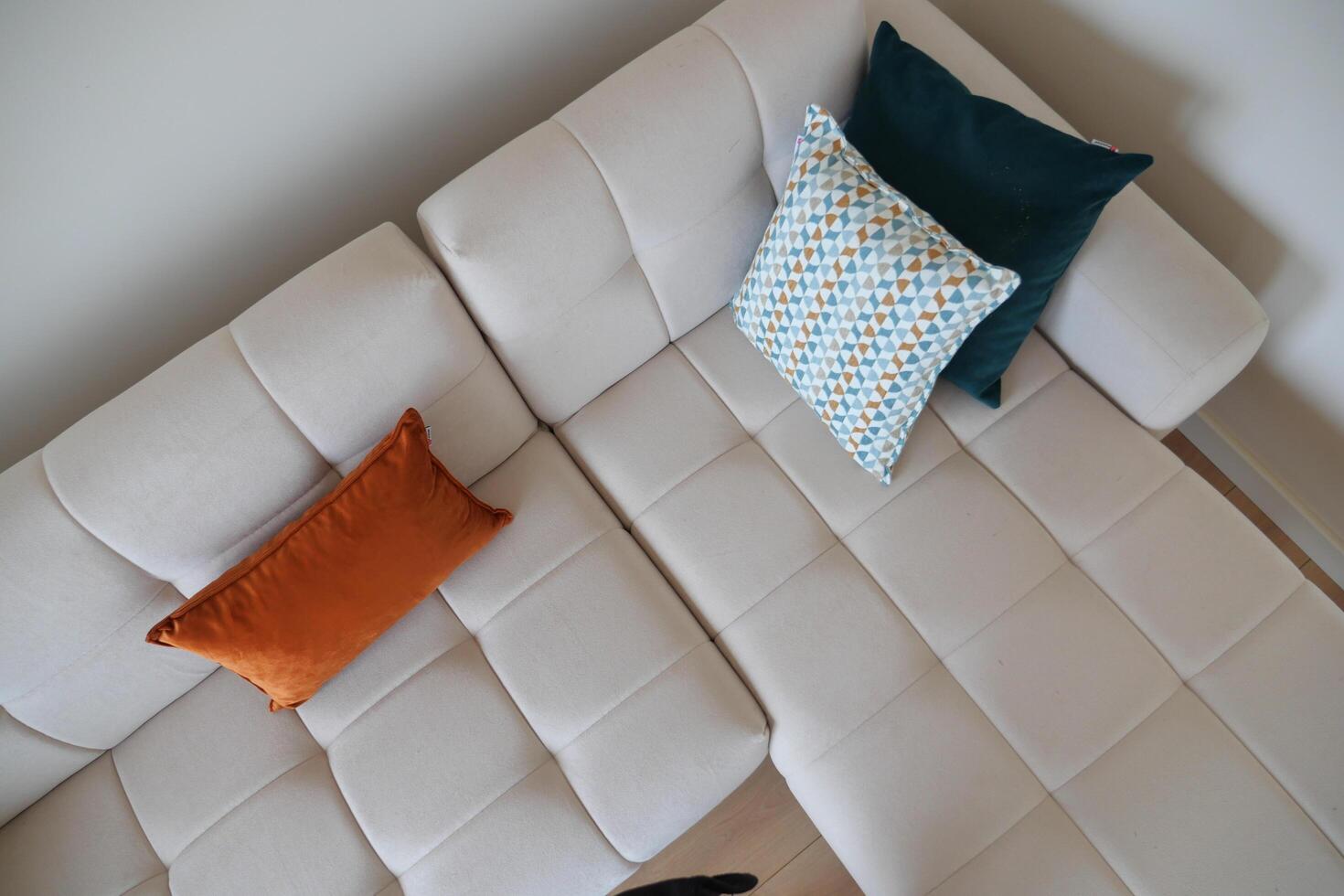 top view of modern sofa with pillows in living room at home photo