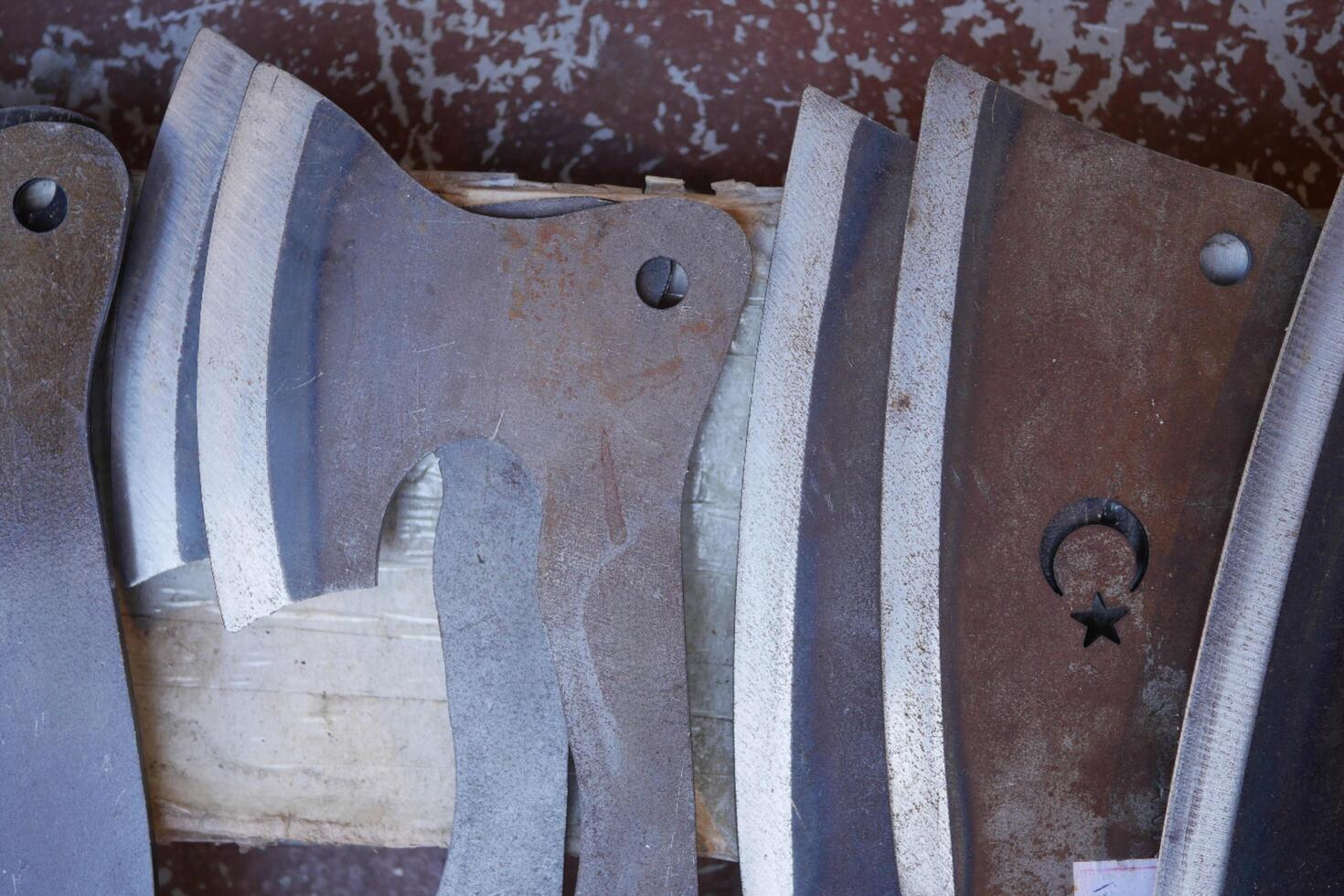 a set of handmade knives on the table photo