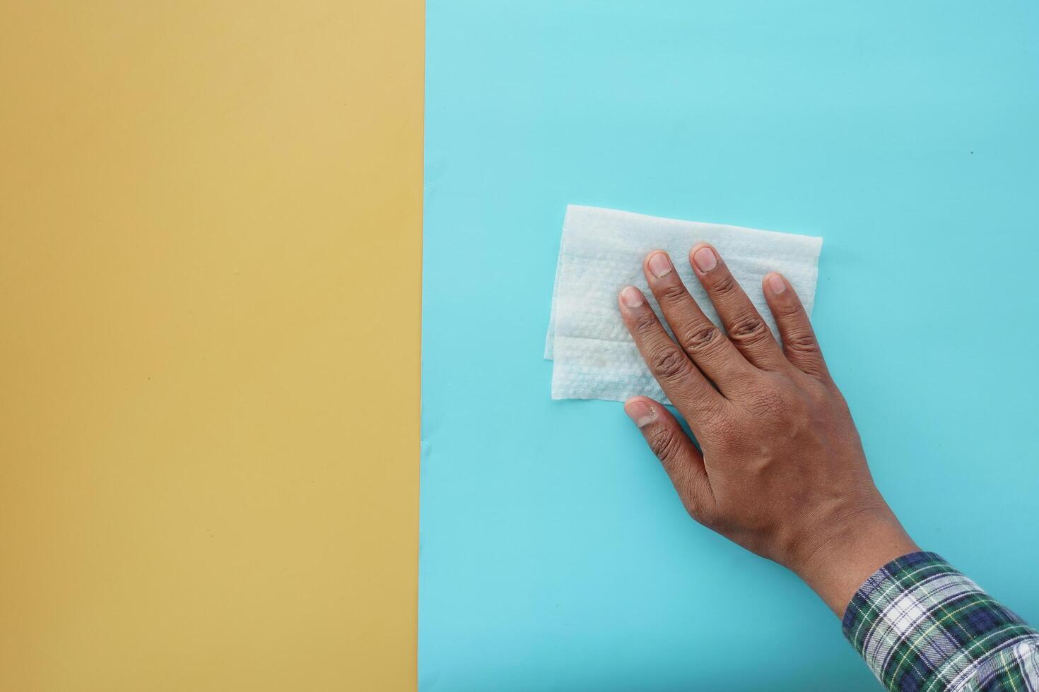 person hand cleaning table with cloth photo