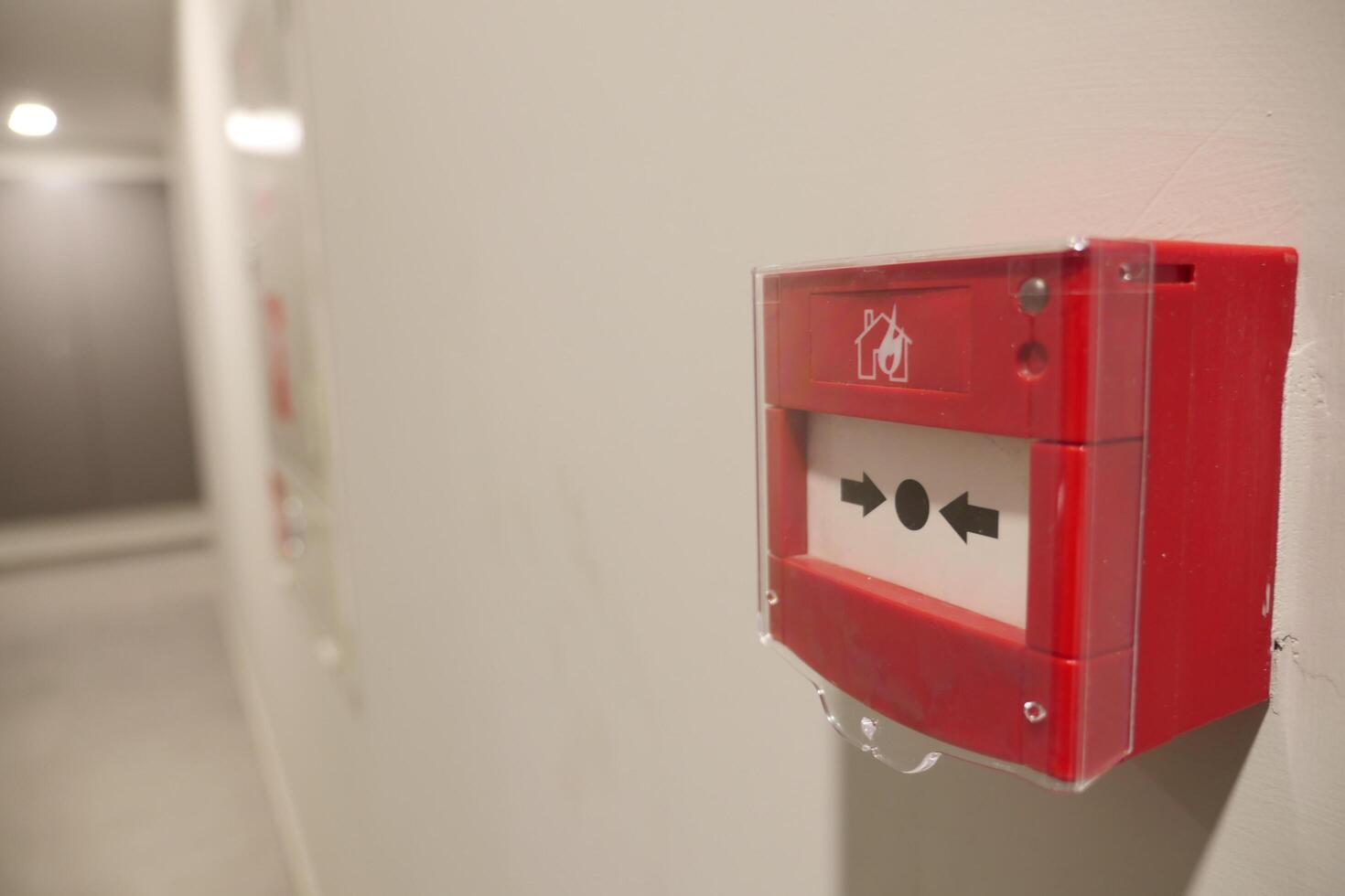 Red fire alarm button on wall , photo