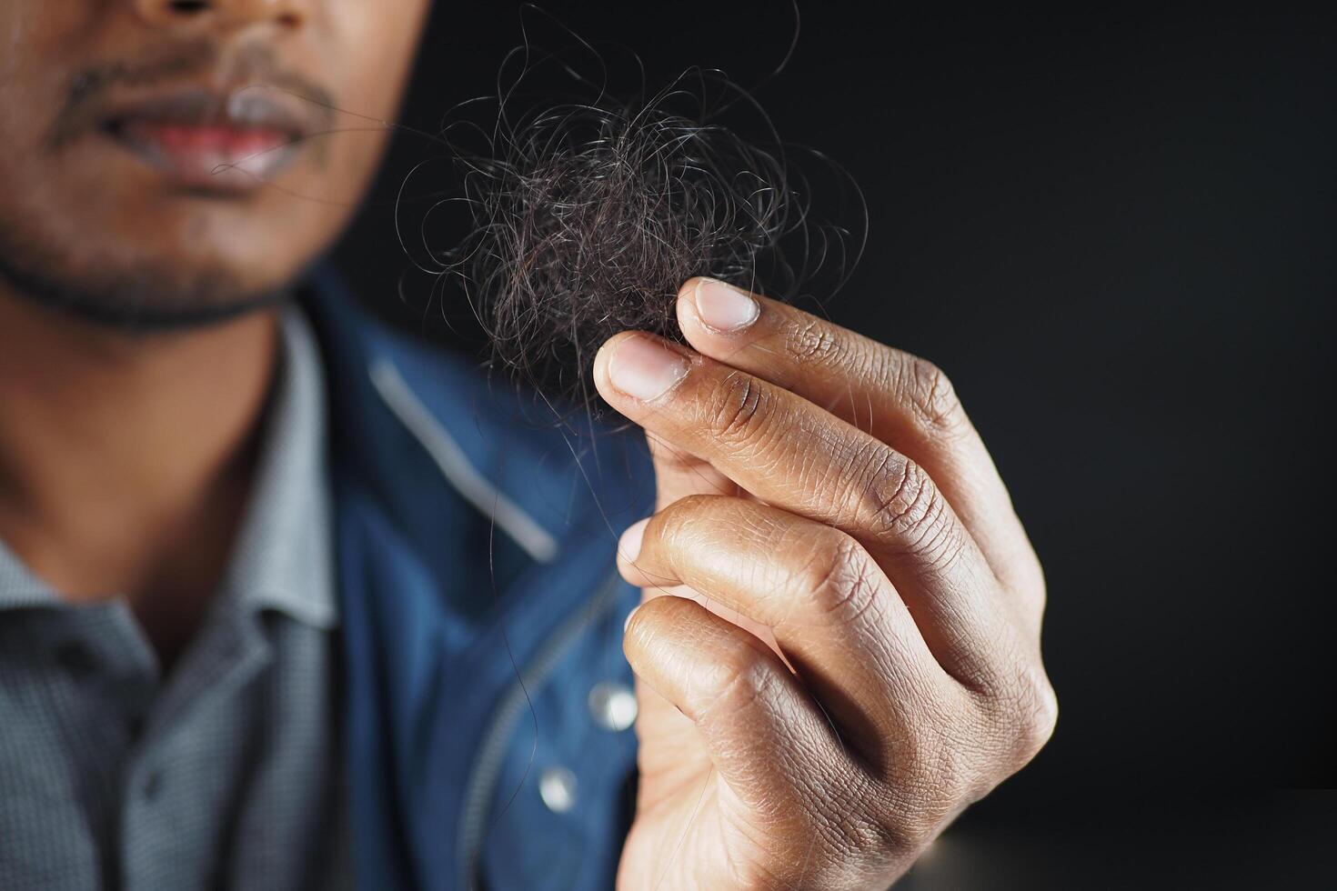 man hold his list hair close up photo