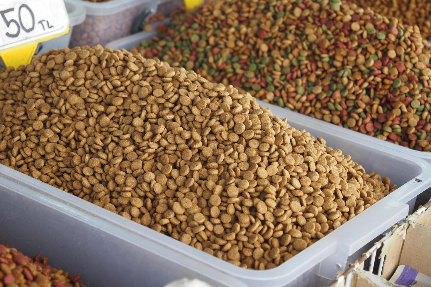 stack of dried cat food display for sale at local market photo