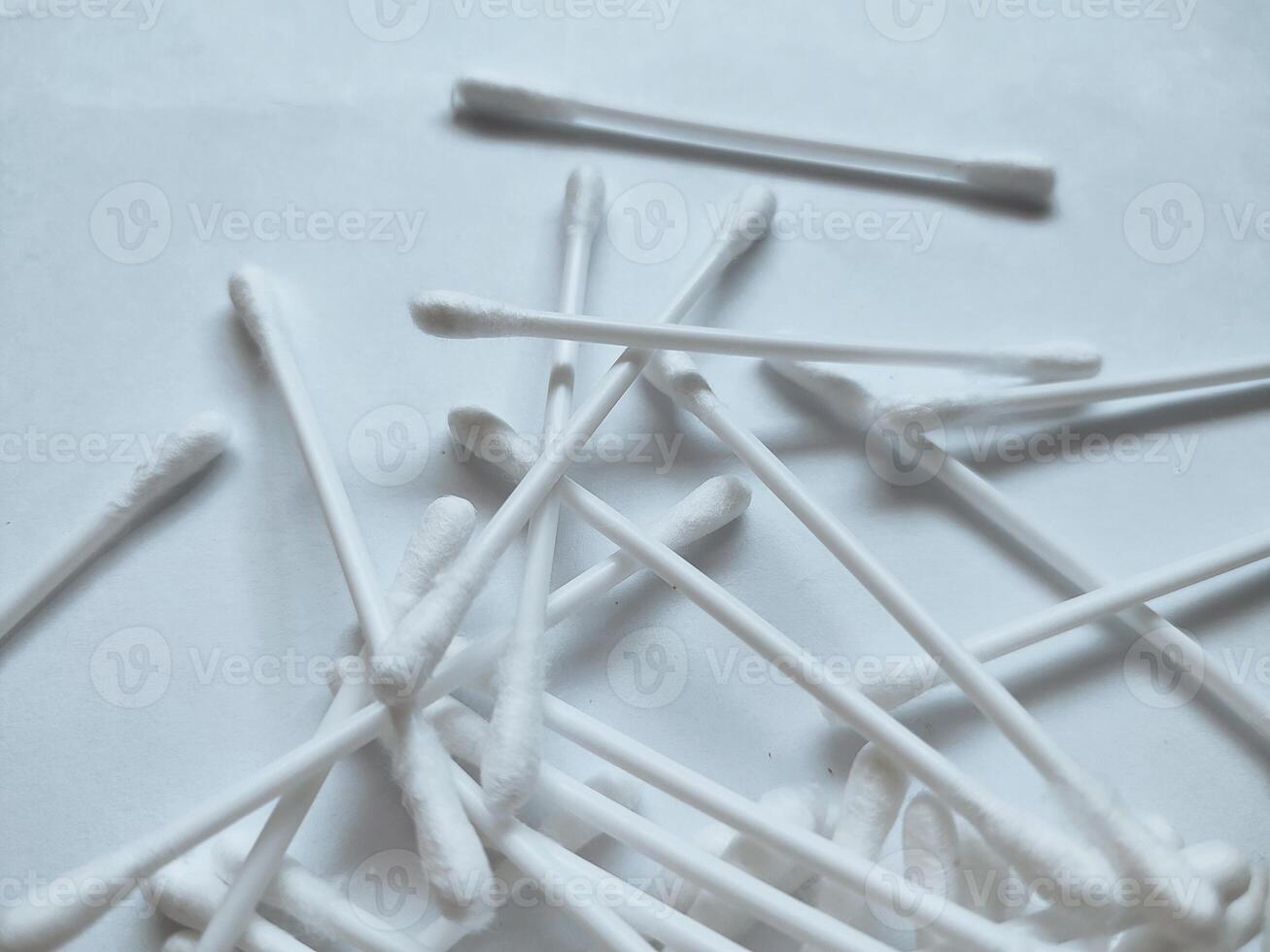 Cotton sticks isolated on the white paper background photo