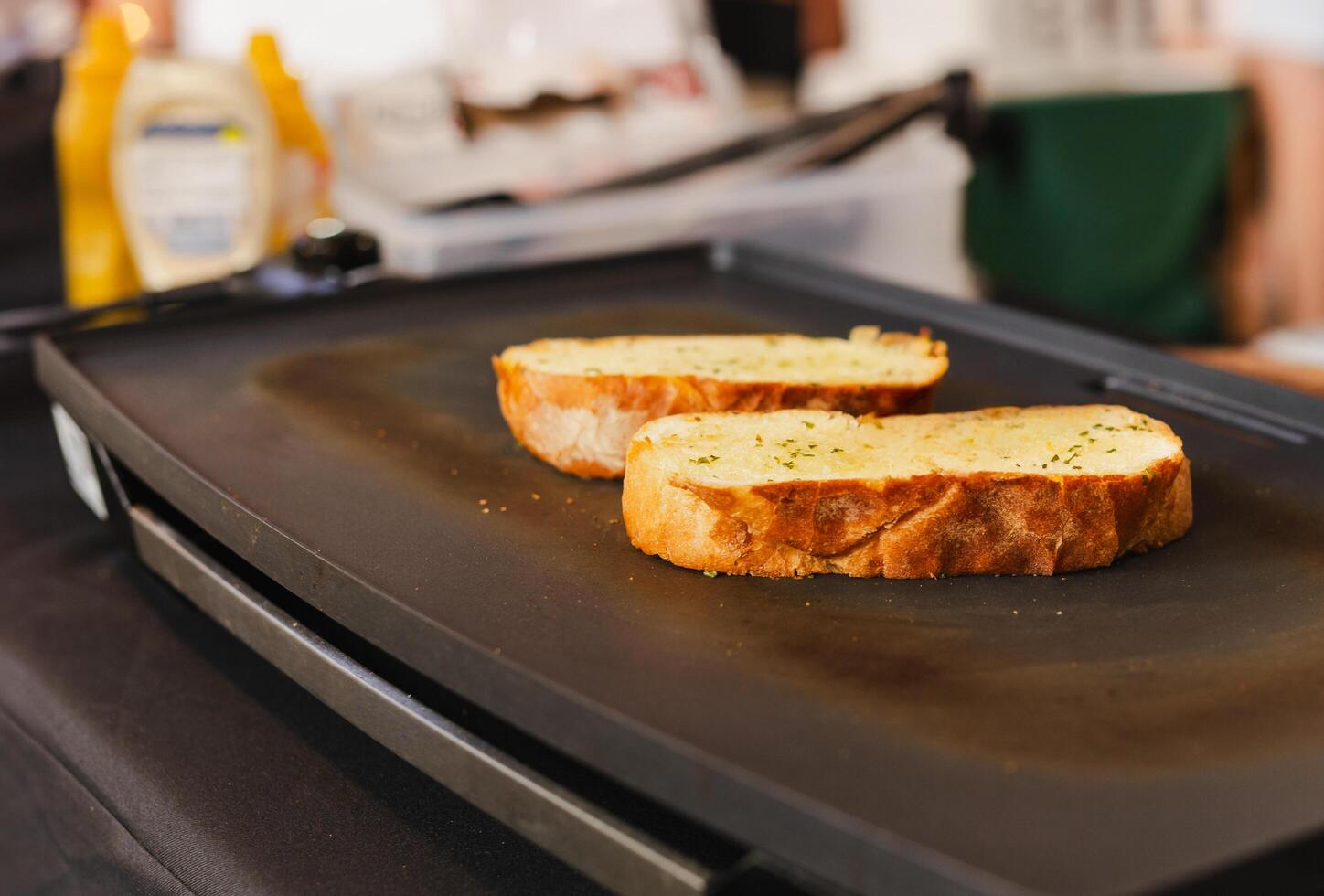 Slice of garlic bread on the hot pan. photo