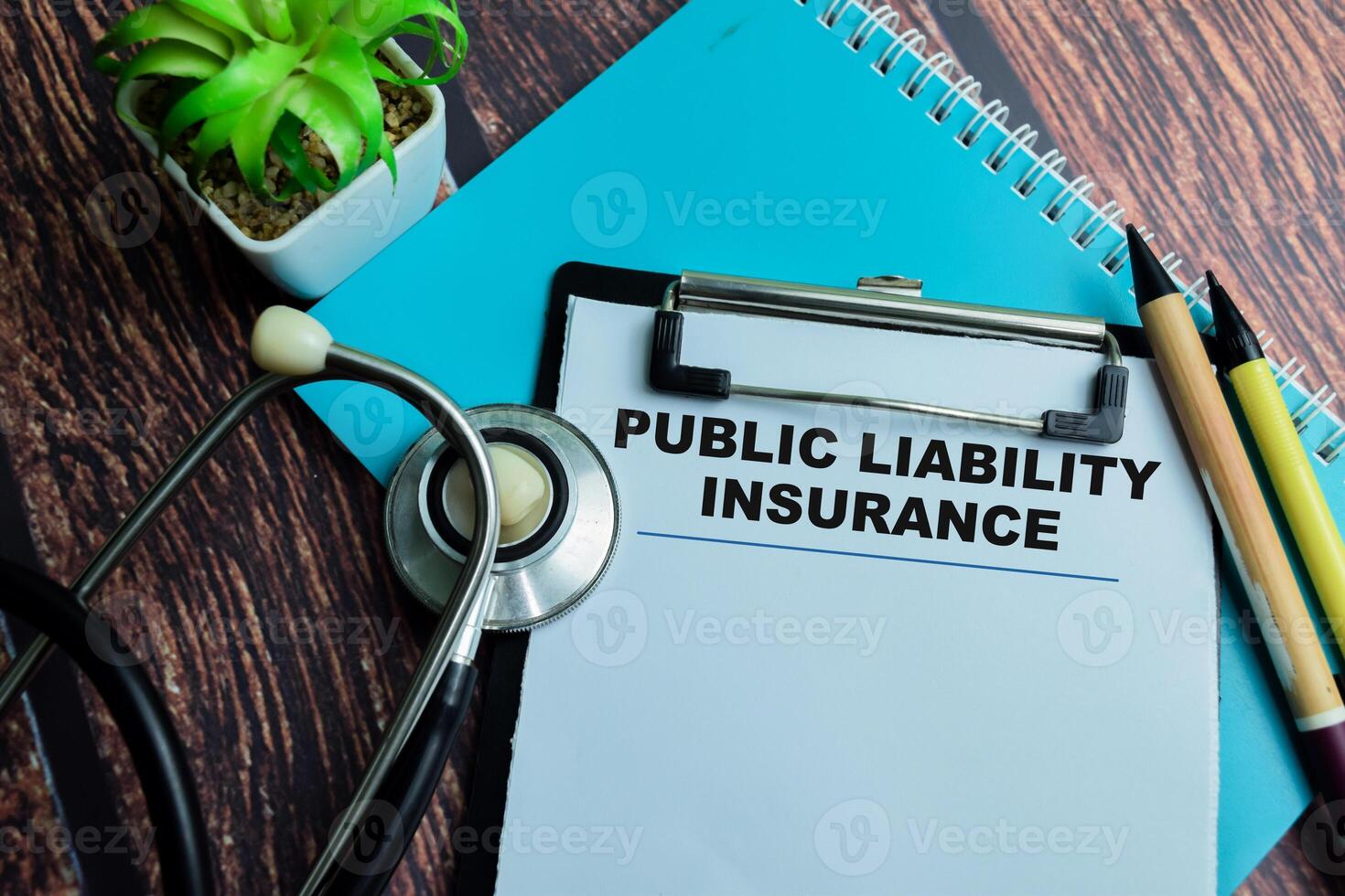 Concept of Public Liability Insurance write on paperwork with stethoscope isolated on wooden background. photo