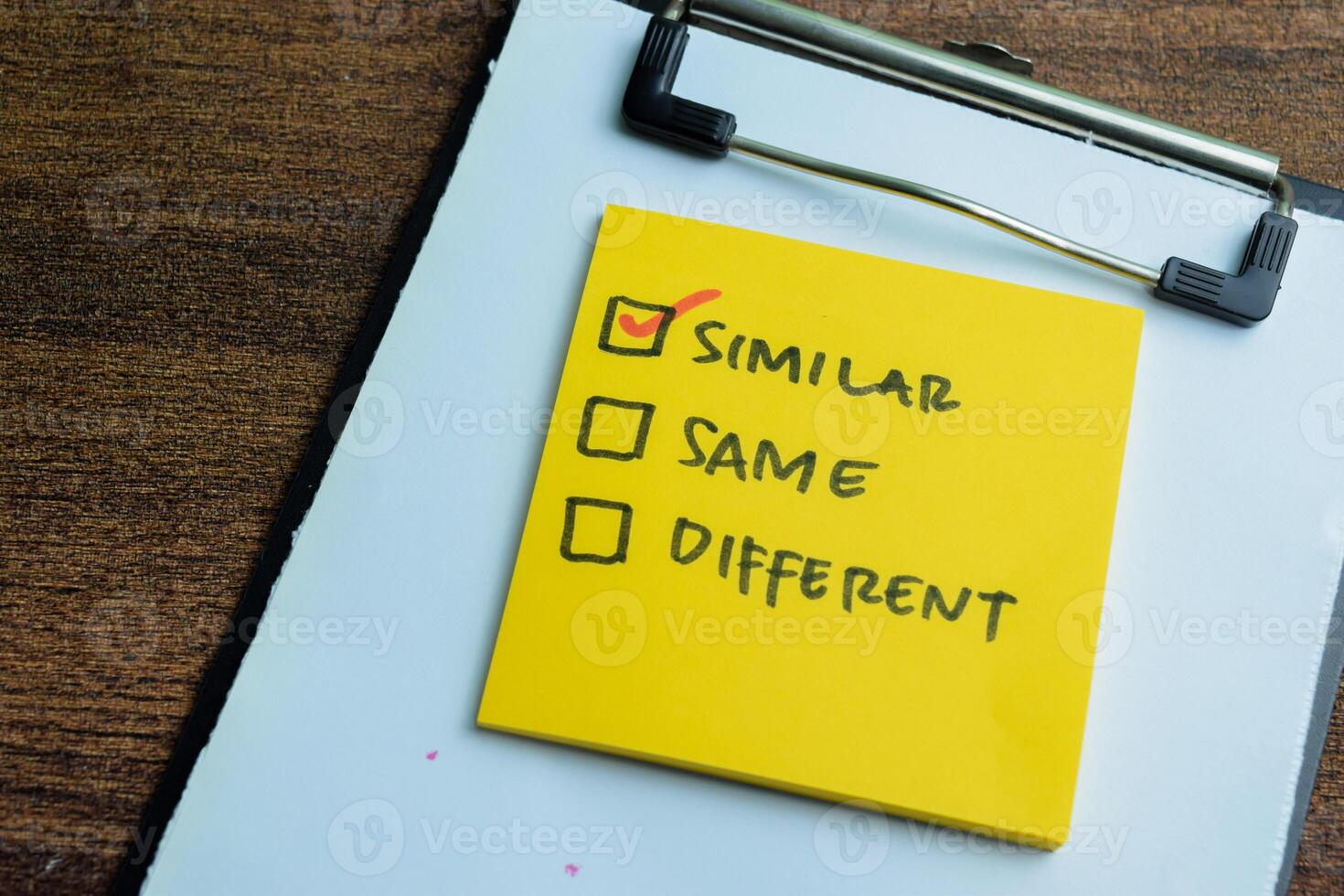 Concept of Similar, Same, Different write on sticky notes isolated on Wooden Table. photo