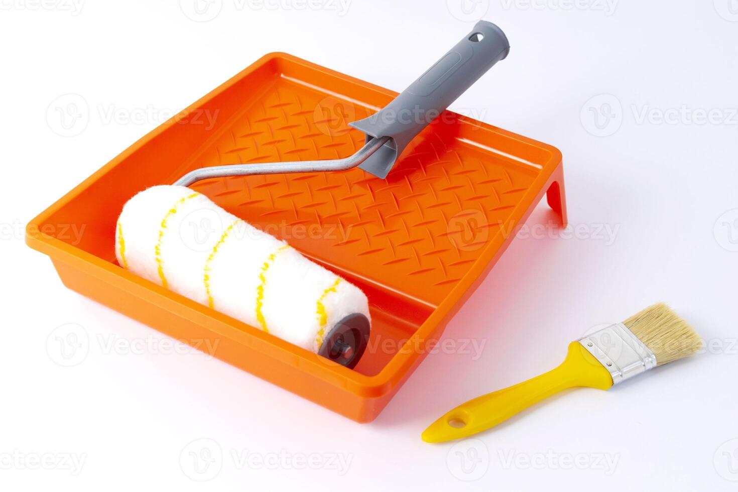Paint can, roller and paint tray for painting wall on the floor photo