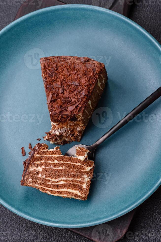 Delicious fresh cheesecake cake or snickers with cream and nuts on a ceramic plate photo