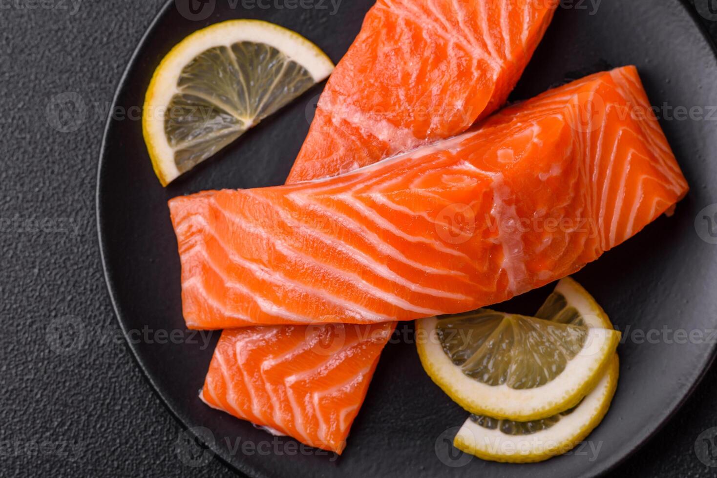 Fresh raw salmon steak with spices and herbs prepared for grilled baking photo