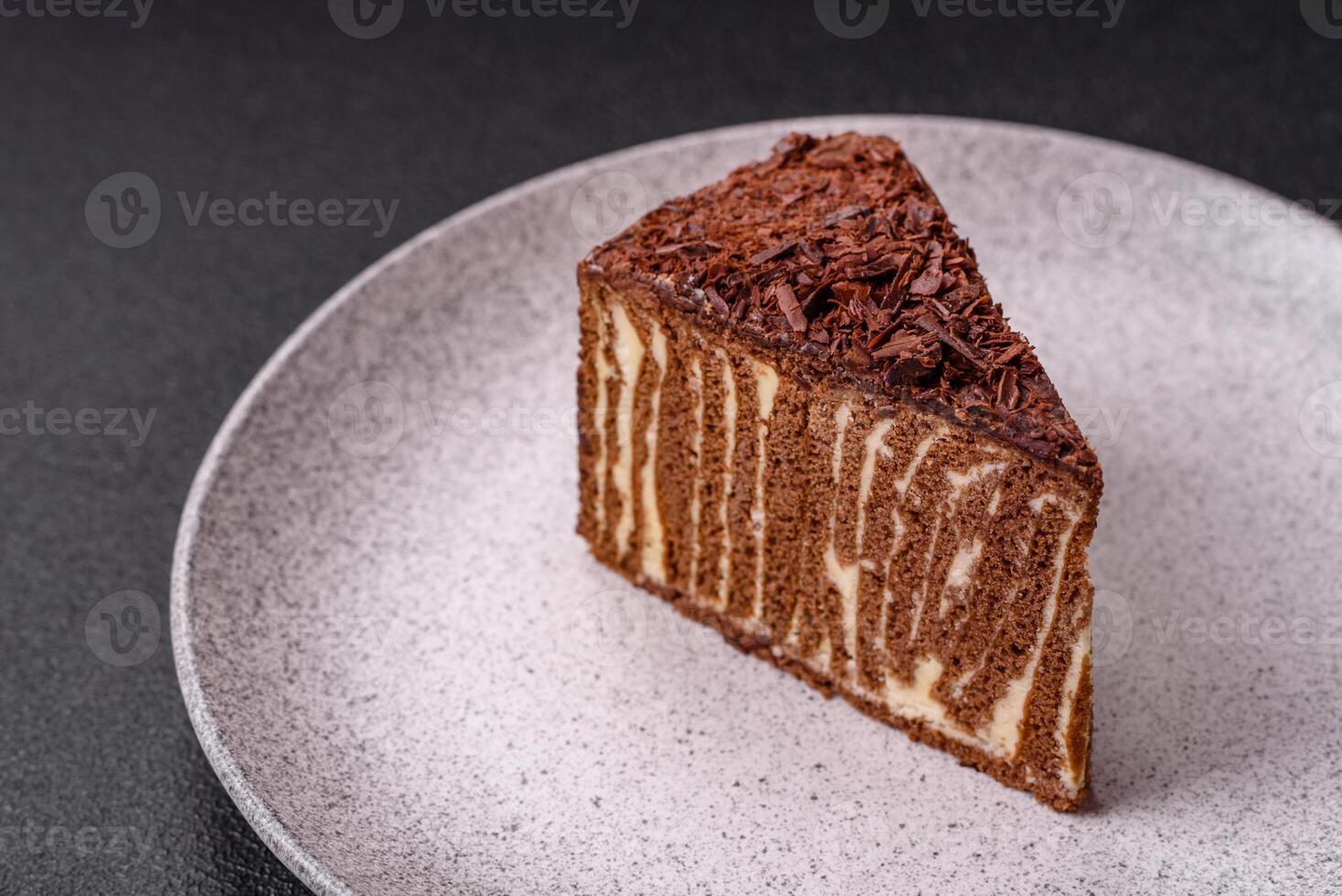 Delicious fresh cheesecake cake or snickers with cream and nuts on a ceramic plate photo