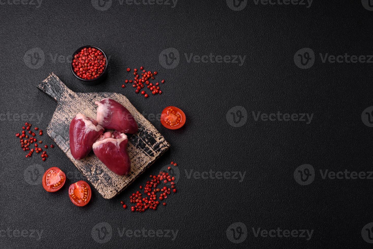 Raw turkey or chicken hearts with salt and spices photo