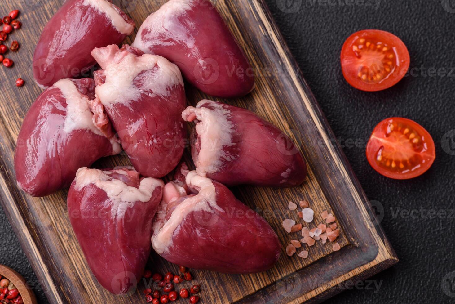 Raw turkey or chicken hearts with salt and spices photo