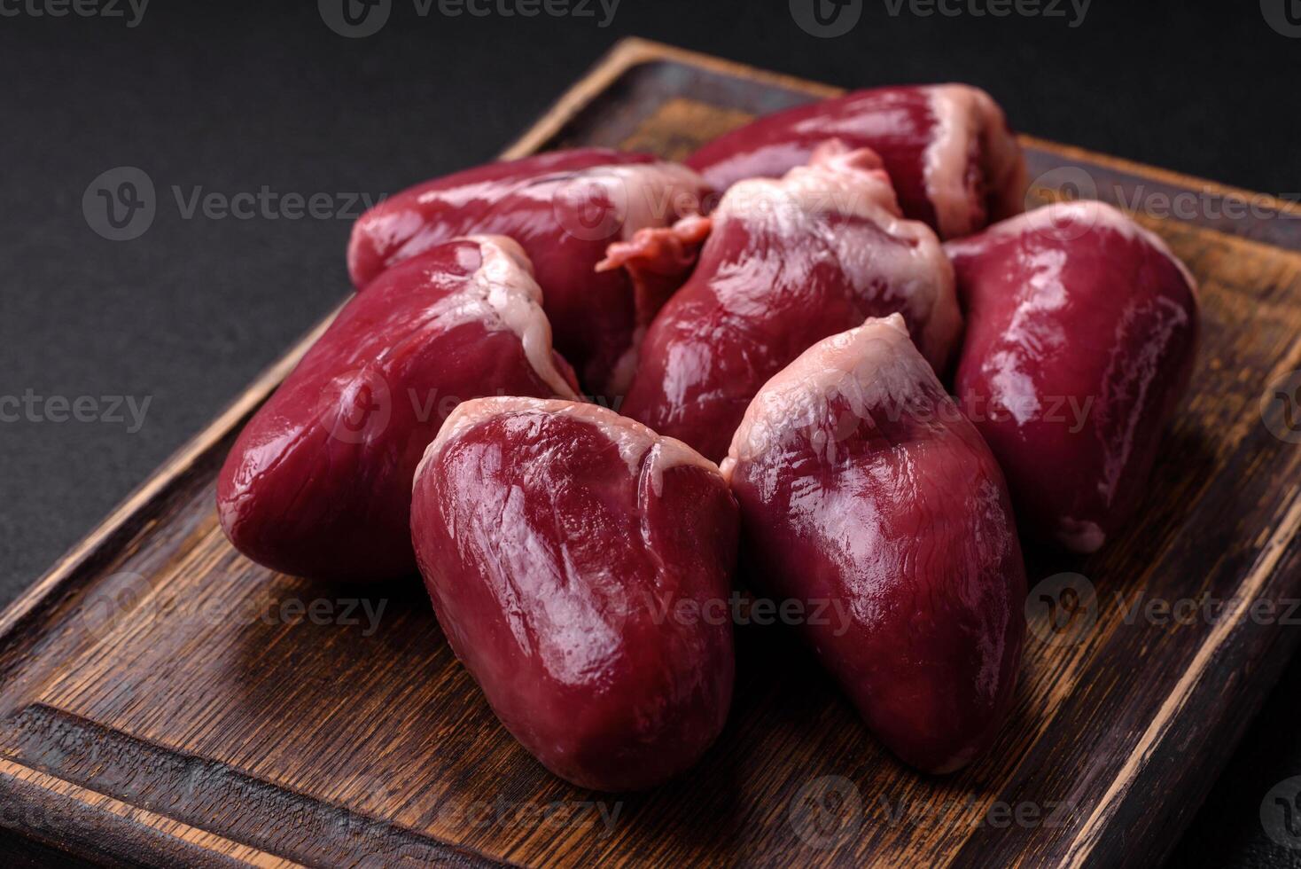 Raw turkey or chicken hearts with salt and spices photo