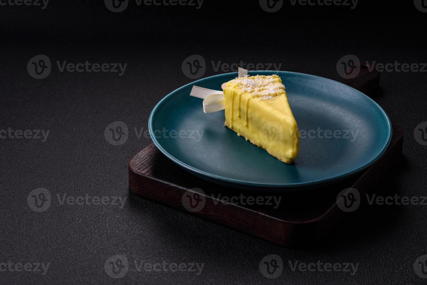 Delicious sweet cheesecake with fruits covered with icing with a wooden stick photo