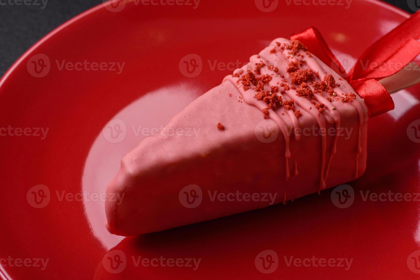 Delicious sweet cheesecake with fruits covered with icing with a wooden stick photo