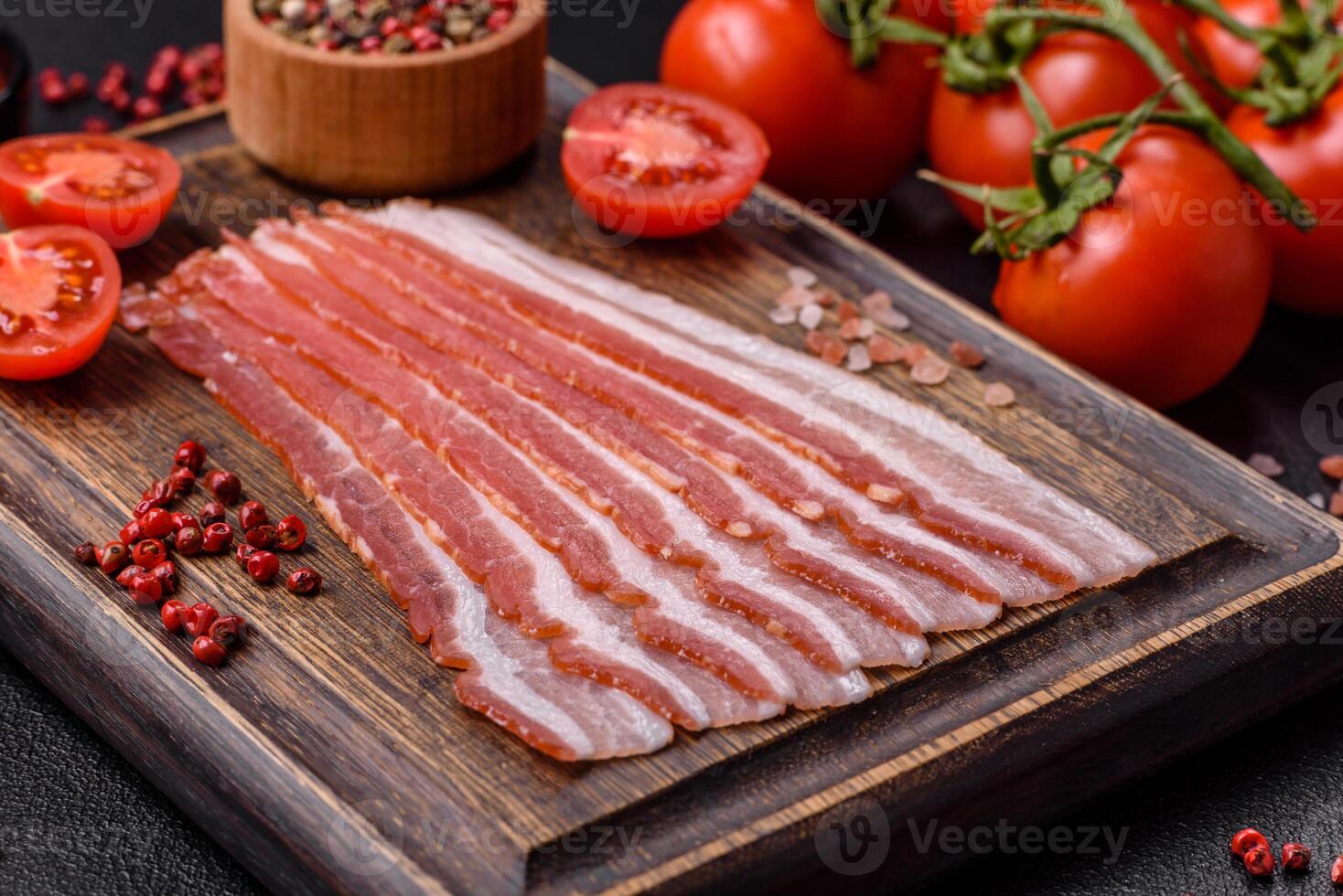 Fresh raw bacon sliced with spices and herbs photo