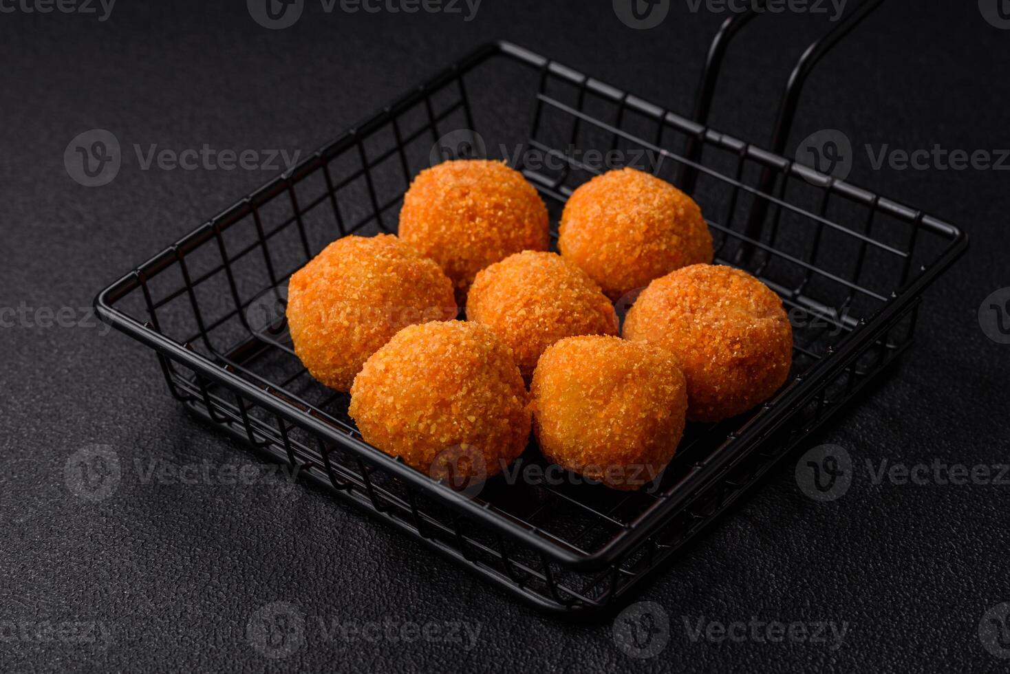 Delicious  balls of mozzarella and parmesan cheese with salt and spices photo