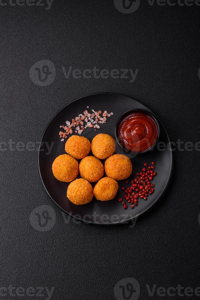 Delicious  balls of mozzarella and parmesan cheese with salt and spices photo