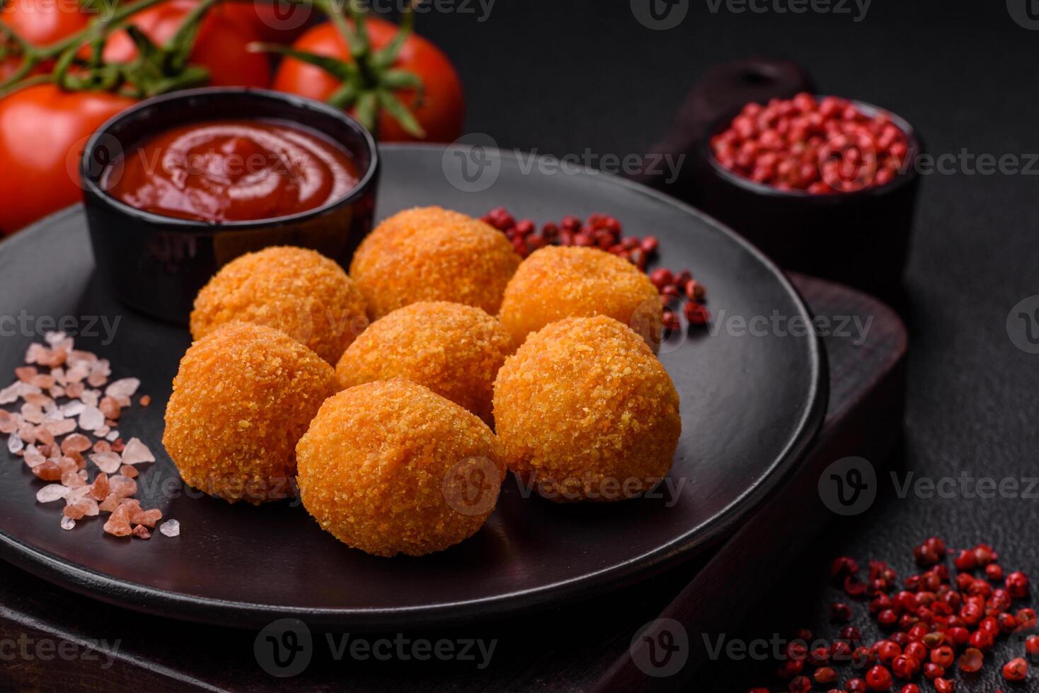 Delicious  balls of mozzarella and parmesan cheese with salt and spices photo