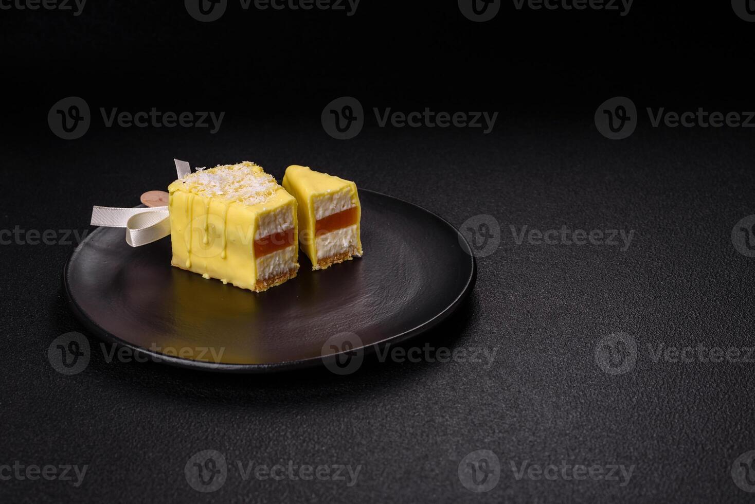 Delicious sweet cheesecake with fruits covered with icing with a wooden stick photo
