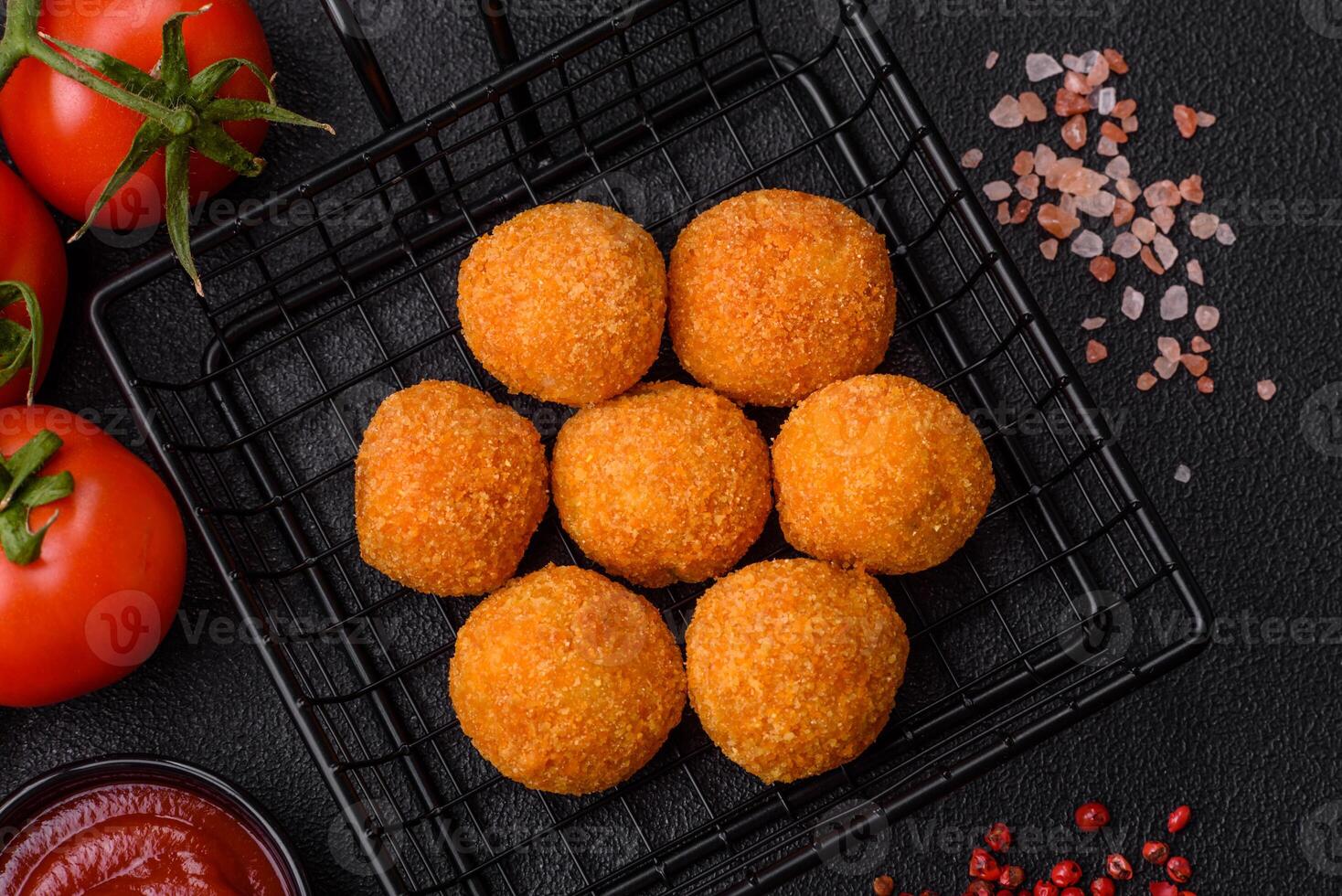 Delicious  balls of mozzarella and parmesan cheese with salt and spices photo