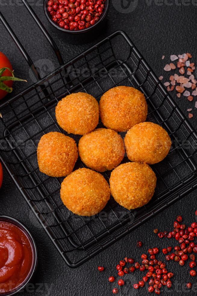 Delicious  balls of mozzarella and parmesan cheese with salt and spices photo