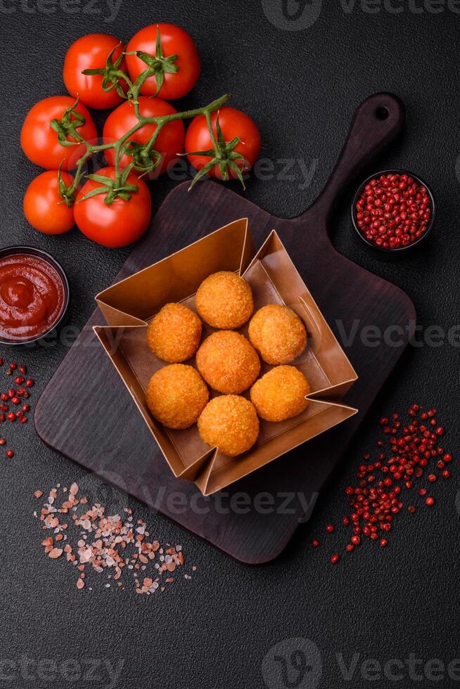 Delicious  balls of mozzarella and parmesan cheese with salt and spices photo